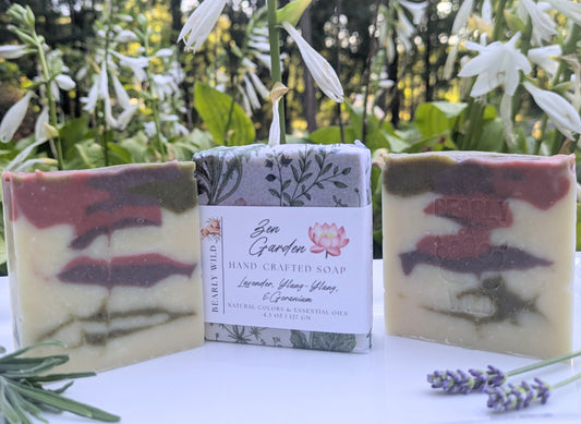 3 creme colored bars with green, pink and purple lines. 